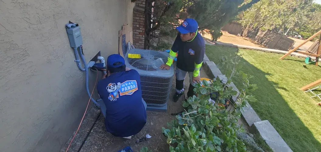 Panda Heating & Cooling crew installing an outdoor condenser unit