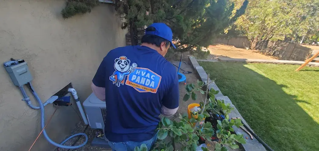 Panda Heating & Cooling technicians working on backyard HVAC equipment